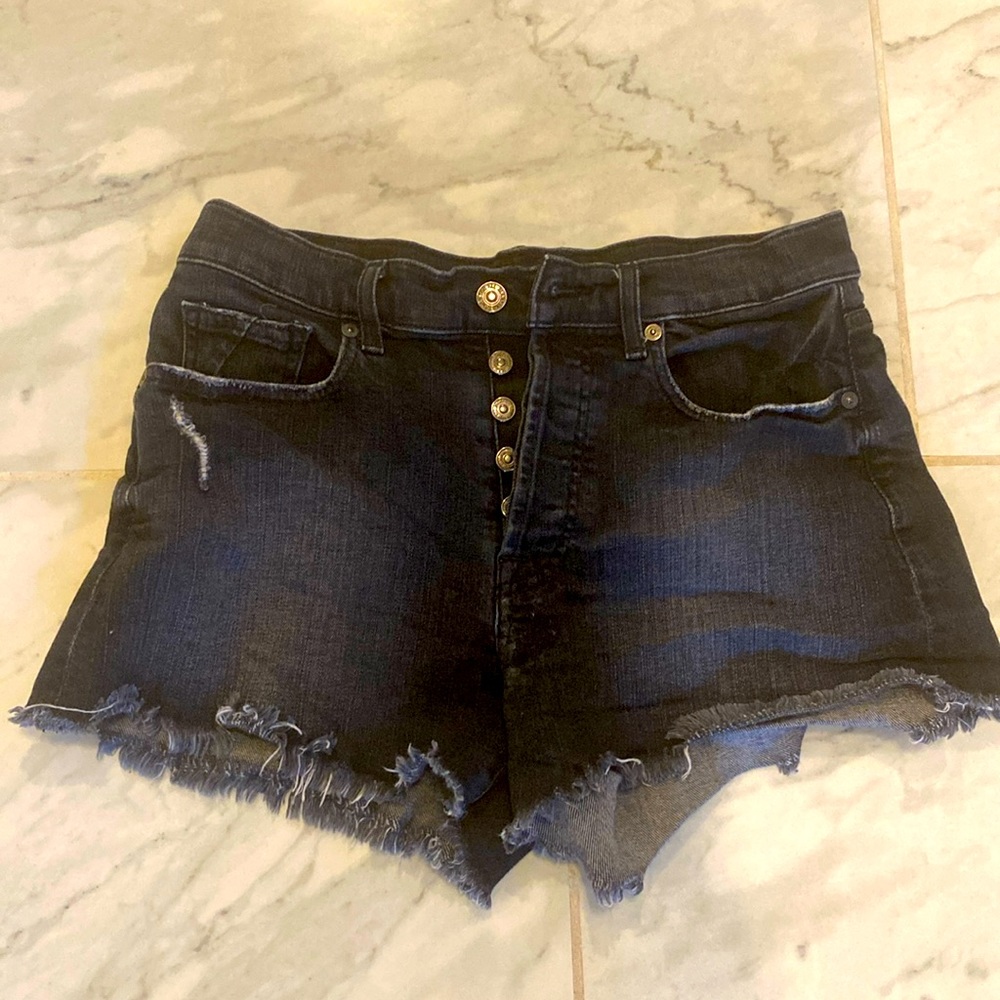 7 for all mankind black distressed denim shorts. Button fly with silver buttons.
